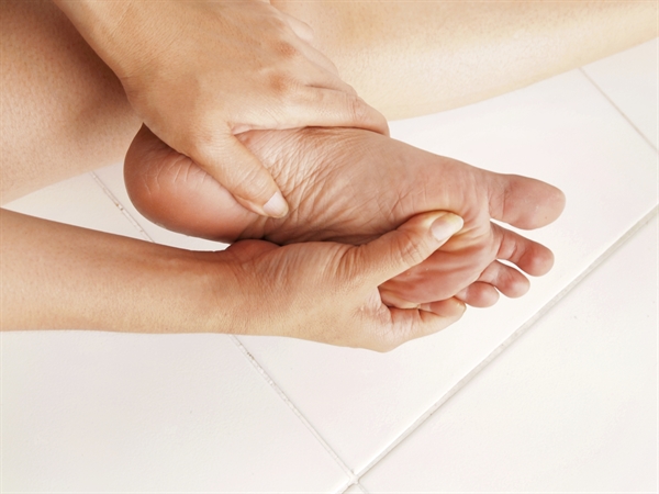man holding legs in pain