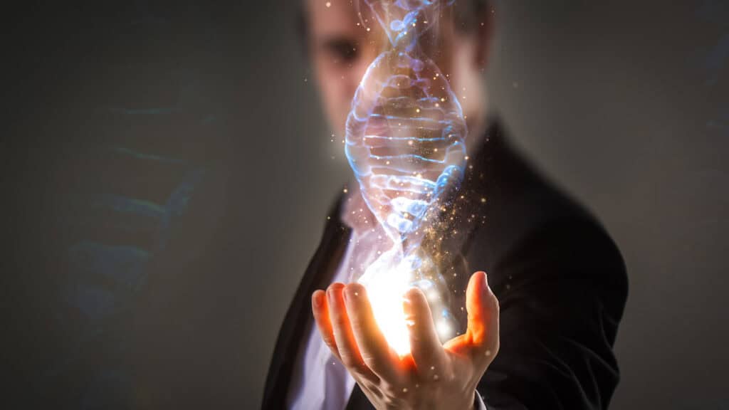 Businessman using his inner powers and holding glowing virtual DNA helix with energy sparks - business, creation, genetics, future and science concept